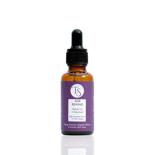 A bottle of AgeRewind Retinol 1% Serum with a dropper, placed against a white background.