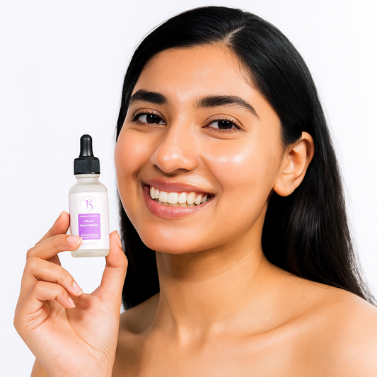 Woman holding a  Alpha Arbutin serum with a plain background