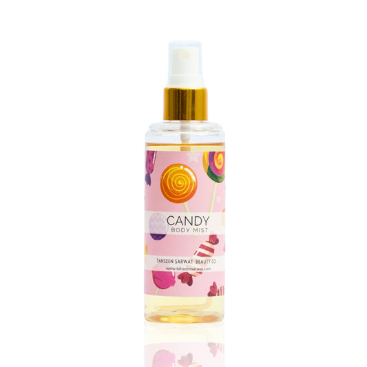 A bottle of Candy Body Mist with a pink label, decorated with images of candies and a gold spray nozzle.