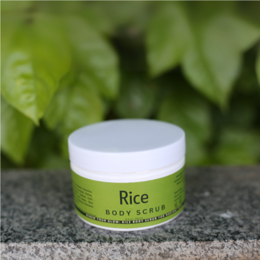 Flat lay of Rice Body Scrub with towel, dry brush, and soft floral accents for a spa vibe.