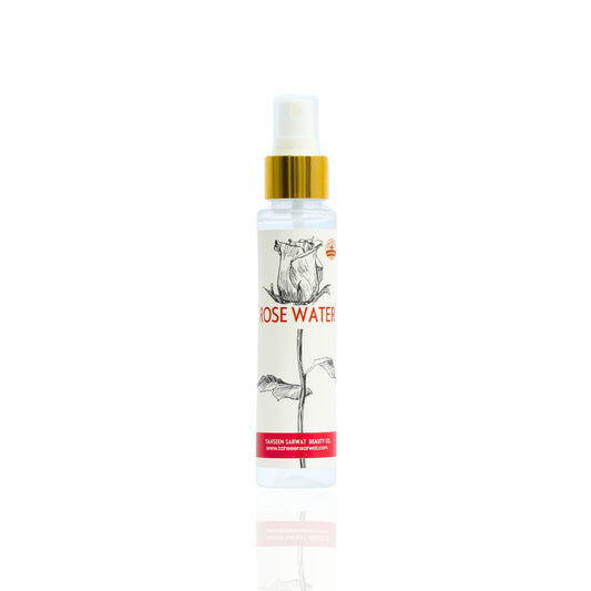 A clear spray bottle labeled ROSE WATER, with a floral design