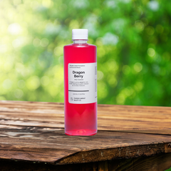 Bottle of Dragon Berry juice on a wooden surface with a blurred green background