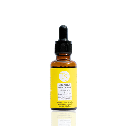A clear glass bottle with a dropper containing yellow-colored liquid, labeled as Vita Glow Vitamin C Serum.