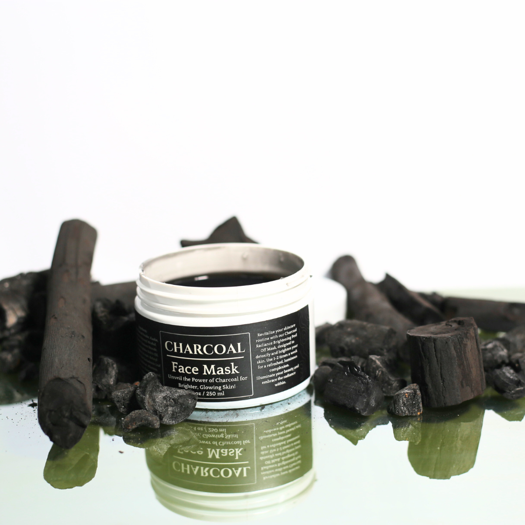 Charcoal Face Mask jar placed next to a brush applicator, towel, and natural ingredients like bamboo charcoal.