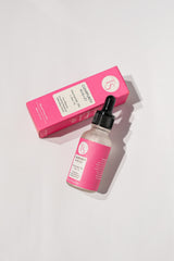 Clear serum dropper bottle shown beside model with smooth, balanced skin