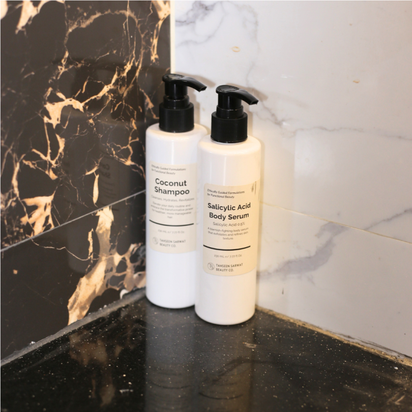 Dropper releasing lightweight, clear serum onto hand or skin, showing thin texture.
