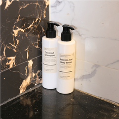 Dropper releasing lightweight, clear serum onto hand or skin, showing thin texture.