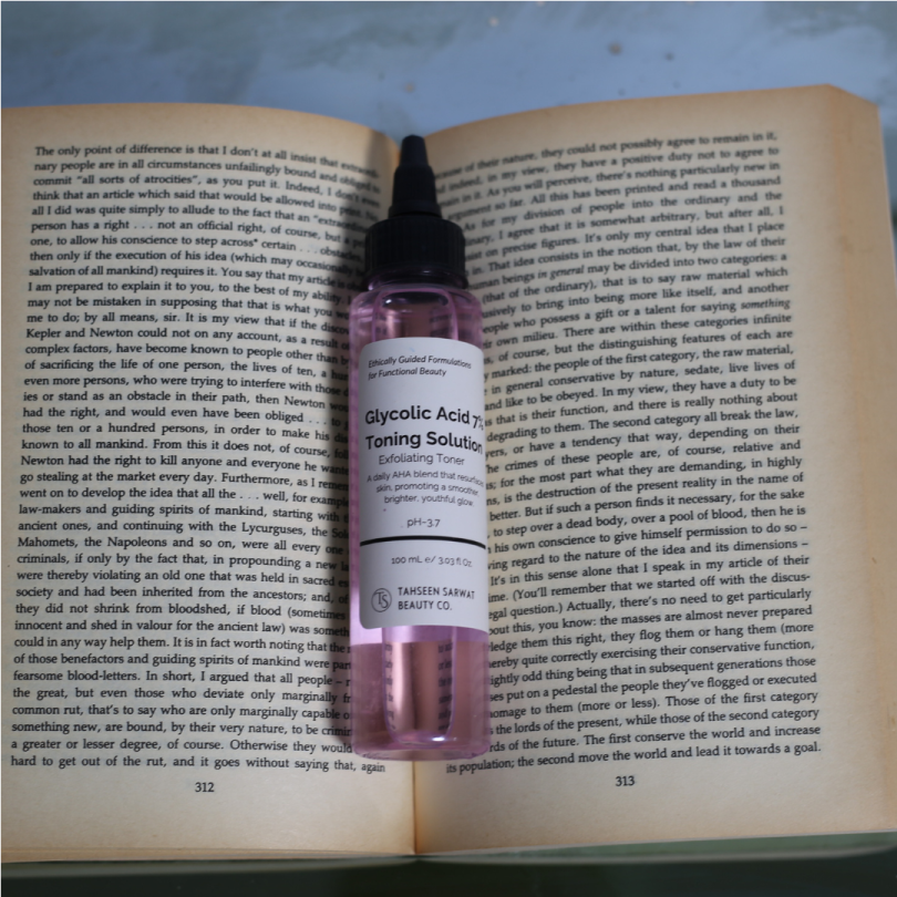 Glycolic acid exfoliating toner placed on a book background for skincare routine