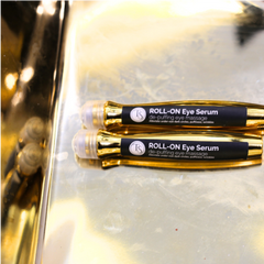 Close-up of metal-tip eye roller gliding on skin for a soothing and cooling effect