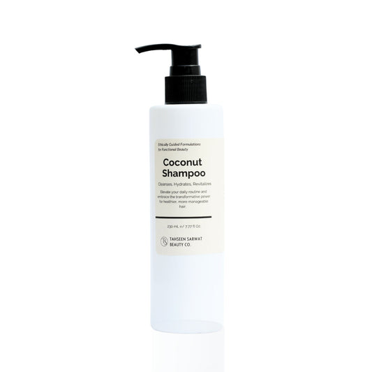A pump bottle of Coconut Shampoo on a white background.