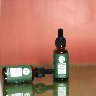 Salicylic acid serum bottle placed beside clear skin icons and blemish-free face