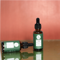 Salicylic acid serum bottle placed beside clear skin icons and blemish-free face