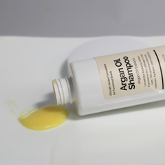 Open Argan Oil Shampoo bottle showing creamy texture or light foam.