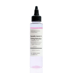 A clear bottle with a black pump dispenser containing a pink-toned liquid labeled as Glycolic Acid 7% Toning Solution.