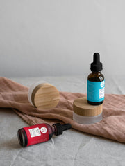 Serum bottle with water splash and moisture-lock icons