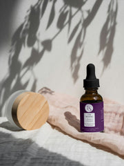 Nighttime retinol serum shown in a dark-themed flat lay with stars and moon graphics